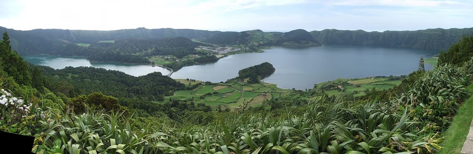 Lagoa das Sete Cidades on São Miguel, seen from above beneath a broad Atlantic sky
